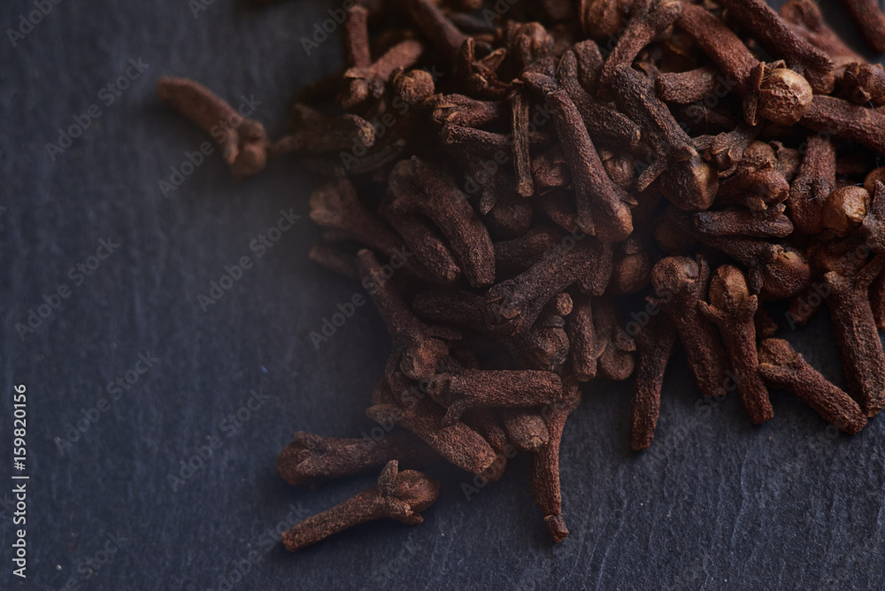 macro photo of spices cloves on dark background for food layouts design or food blogs and etc. macro photo of spices cloves on dark background for food layouts design or food blogs and etc.