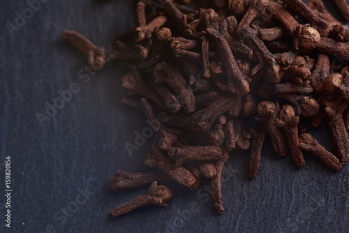 macro photo of spices cloves on dark background for food layouts design or food blogs and etc.