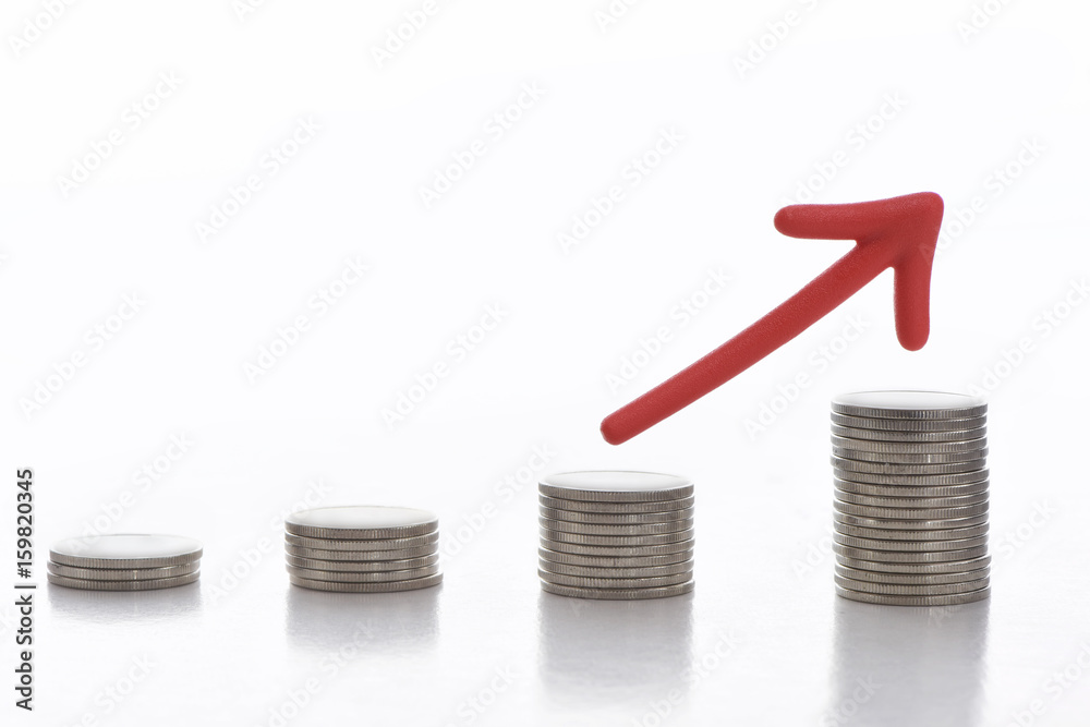 Stack of coins with red arrow on white background, business challenge concept and growth idea Stack of coins with red arrow on white background, business challenge concept and growth idea