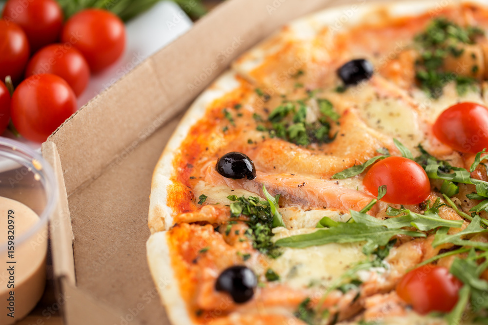 italian pizza with salmon, tomatoes, arugula and cheese italian pizza with salmon, tomatoes, arugula and cheese