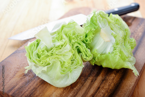 fresh green iceberg lettuce on cutting board