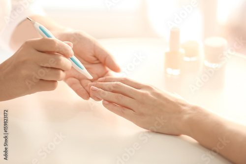 Woman making manicure in salon