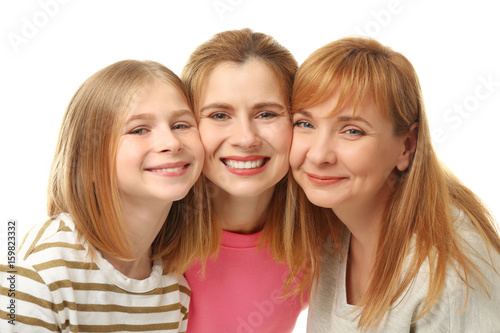 Happy young woman with her mother and daughter on white background