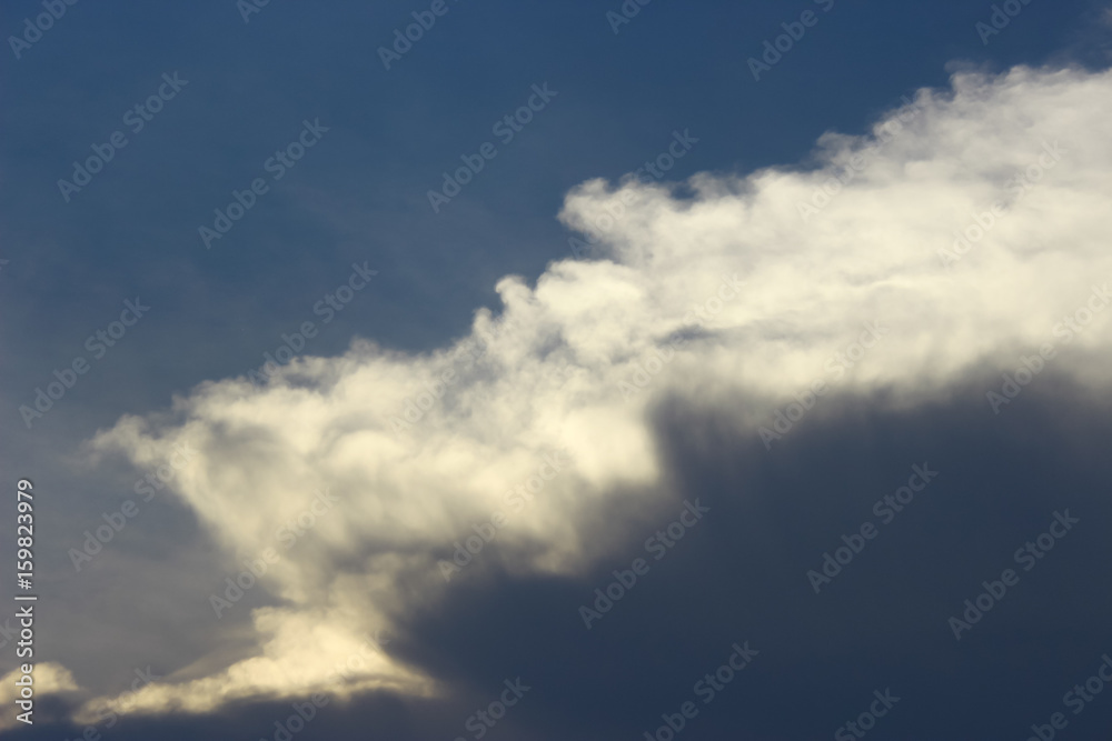 Photo of gray clouds approaching in blue sky