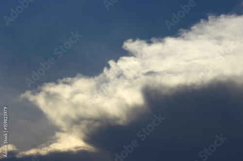 Photo of gray clouds approaching in blue sky