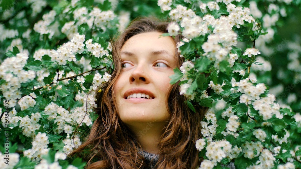 young happy smiling green-eyed woman with flowers. natural beauty