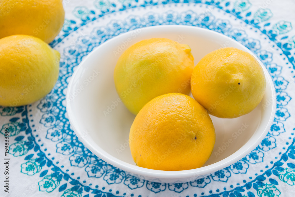 Bowl of fresh Lemons on Blue mandala tablecloth