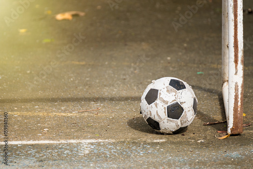 Old soccer ball on the cement floor. © bubbers