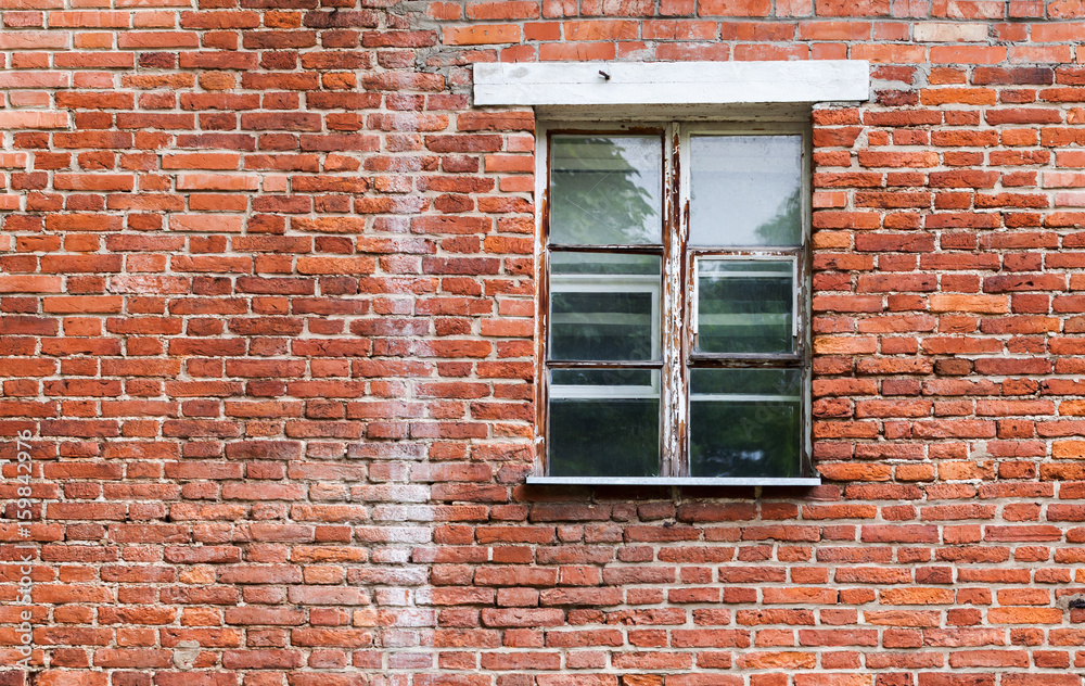 Window with wooden frame in old brick wall