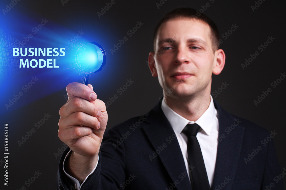 The concept of business, technology, the Internet and the network. A young entrepreneur working on a virtual screen of the future and sees the inscription: Business model The concept of business, technology, the Internet and the network. A young entrepreneur working on a virtual screen of the future and sees the inscription: Business model