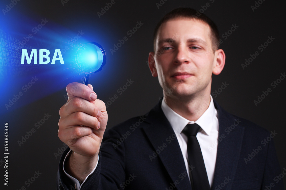 The concept of business, technology, the Internet and the network. A young entrepreneur working on a virtual screen of the future and sees the inscription: MBA The concept of business, technology, the Internet and the network. A young entrepreneur working on a virtual screen of the future and sees the inscription: MBA