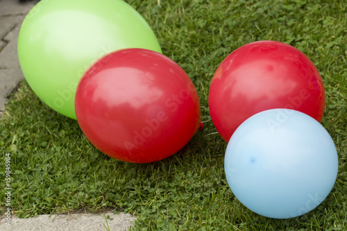 Inflatable balloons lying on the grass.