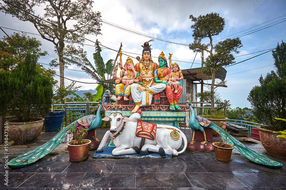 Hindu gods Shiva, Parvati, Ganesha and Murugan sitting on the throne with  white sacred cow and two peacocks below. Statue at Sri Aruloli Thirumurugan  Temple. Stock Photo | Adobe Stock