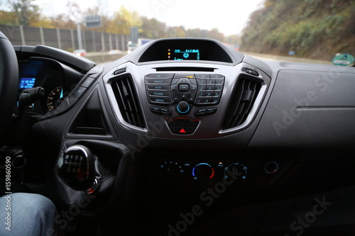 balck luxury car from inside. Close up of steering wheel, seat and circuit