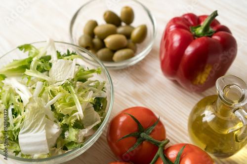 Salad ingridients. Tomato, lettuce, paprika and olive oil.