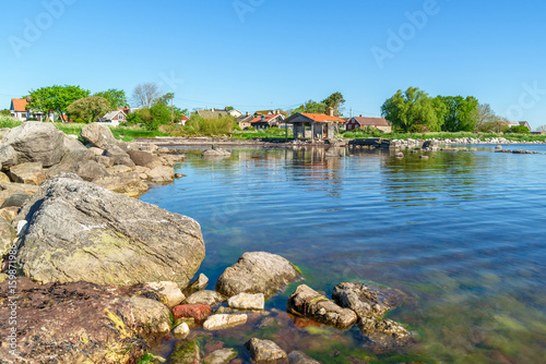 The seaside village of Ossby on southern Oland in Sweden. Here seen from the sea looking toward the abandoned boathouse on the shore.