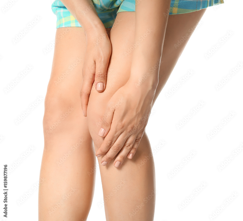 Young woman suffering from pain in leg on white background, closeup Young woman suffering from pain in leg on white background, closeup