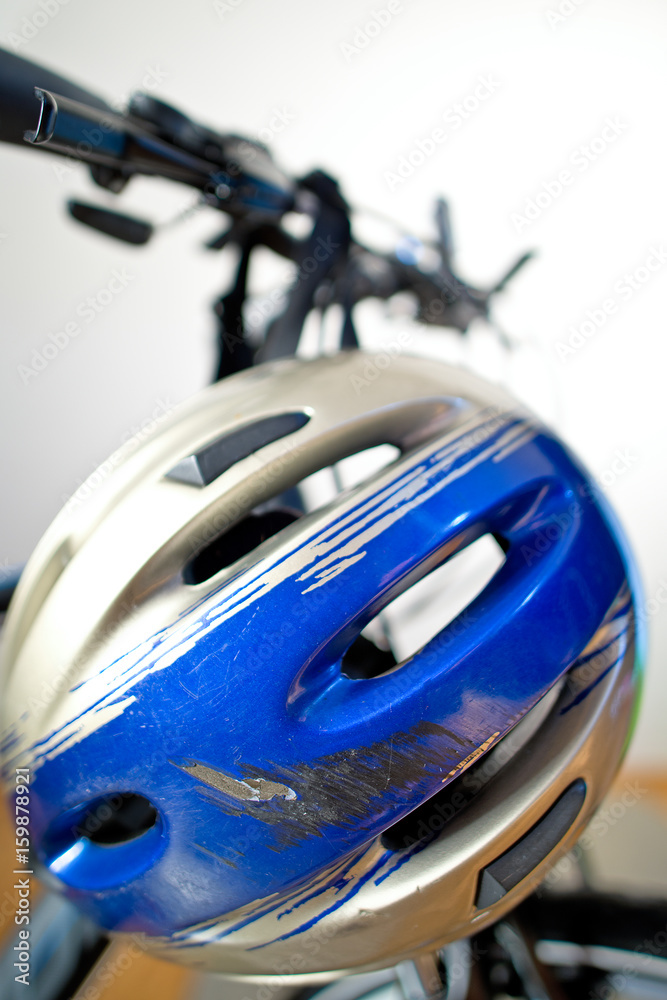 Fototapeta premium Old Scraped Safety Helmet On The Bike