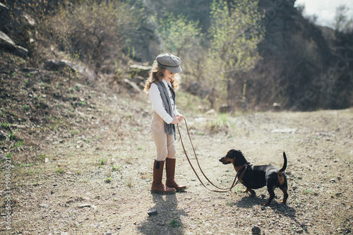 Girl with a dog in the nature