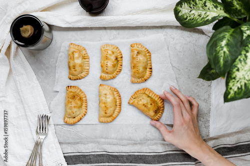 Eating Freshly Baked Empanada's in Kitchen