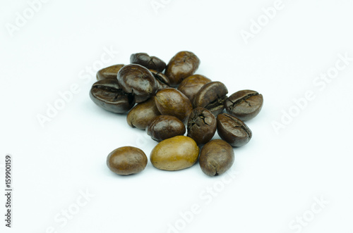 Close-up view of a pile of coffee beans isolated on a white background
