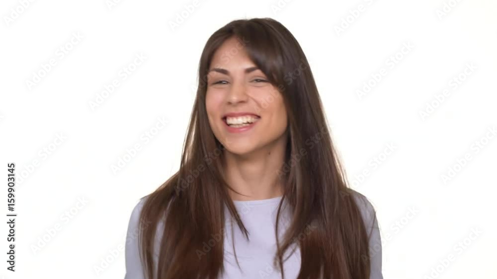 Crazy happy beautiful Caucasian female with long brunette hair jumping and screaming with joy over white background Crazy happy beautiful Caucasian female with long brunette hair jumping and screaming with joy over white background