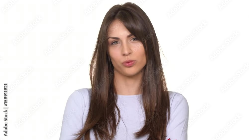Calm young beautiful Caucasian lady with brunette hair saying no and shaking head in disbelief over white background Calm young beautiful Caucasian lady with brunette hair saying no and shaking head in disbelief over white background