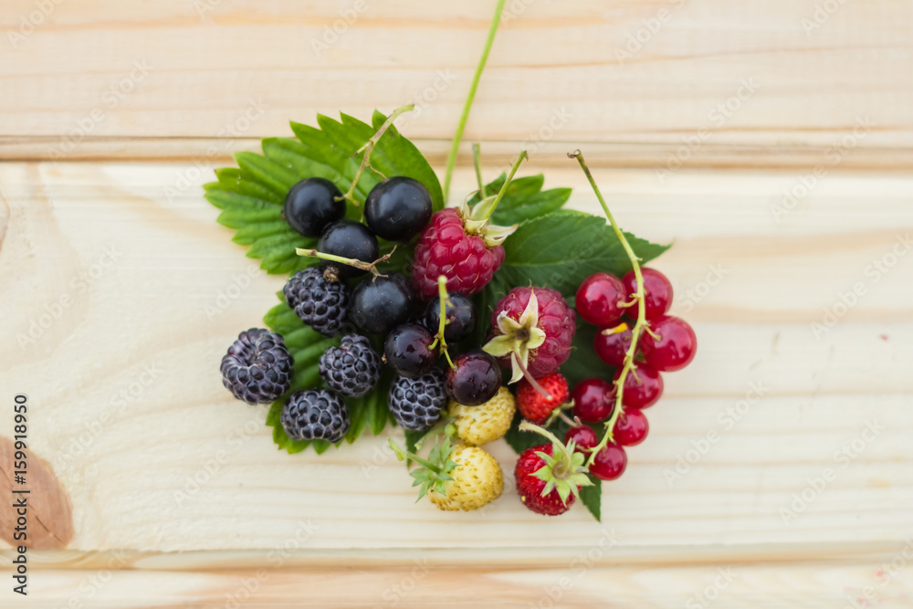 red and black raspberries on a wooden table red and black raspberries on a wooden table