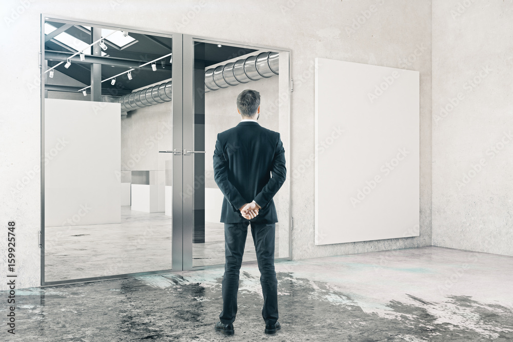 Fototapeta premium Businessman in room with whiteboard
