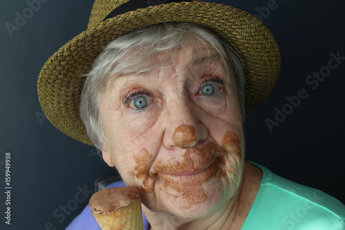Happy senior woman eating ice cream