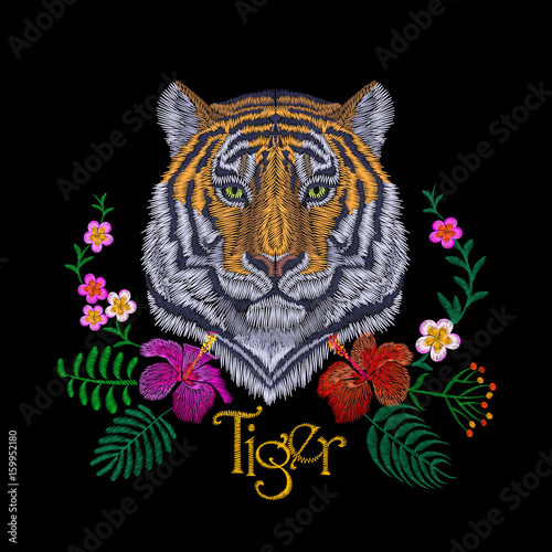 Fototapeta Naklejka Na Ścianę i Meble -  Tiger head tropic flower. Front view embroidery patch sticker. Orange striped black wild animal stitch texture textile print. Jungle logo vector illustration