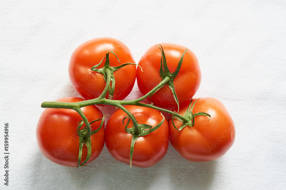 Tasty tomatoes on a branch in cardboard red box