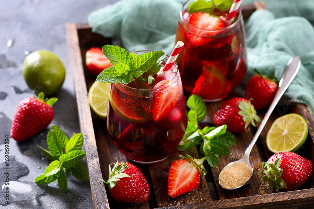 Strawberry mojito drink, refreshing summer lemonade with strawberries, lime and mint