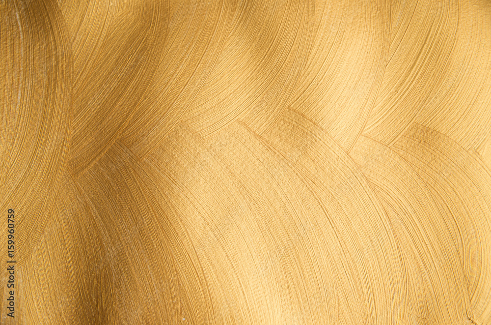 Golden glittering paintful textured background made with brush Golden glittering paintful textured background made with brush