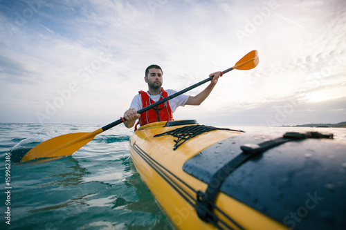 Man paddling sea kayak © yossarian6