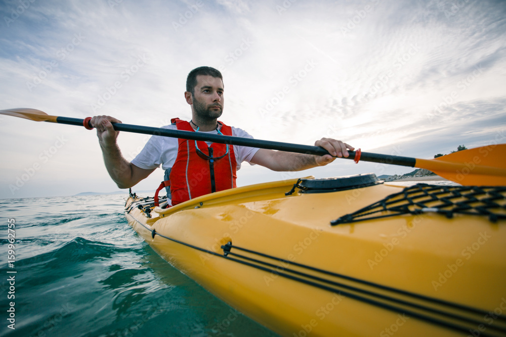 Kayaker man paddling a kayak