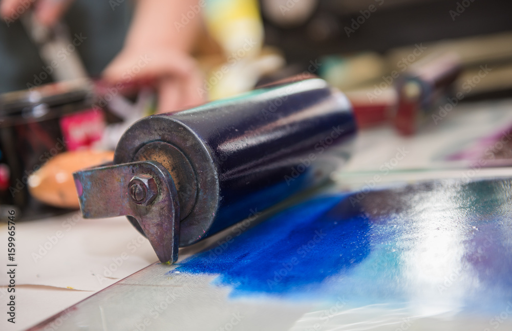 an acrylic paint roller for mono printing and screen printing, rolling paint ready for mono printing. an acrylic paint roller for mono printing and screen printing, rolling paint ready for mono printing.