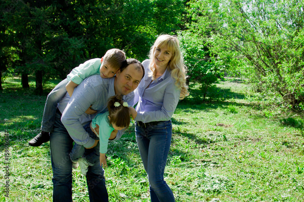 Fototapeta premium Portrait of a family of four outdoors.
