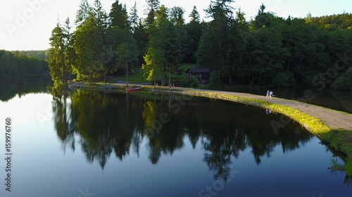 View of a lake in germany flying above with nice view on the trees. Ebnisee, slow camera move photo