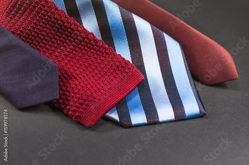 Close up of men's neckties. Modern ties for men isolated on a black background.