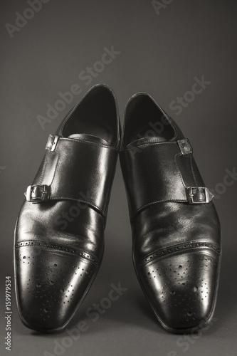 Beautiful black leather men s shoes. Fashionable shoes isolated on black background.