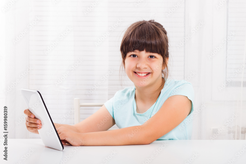 Little girl using digital tablet at ther home. Little girl using digital tablet at ther home.