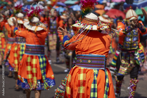 Tinkus dance group in colourful costumes performing a traditional ritual dance as part of the Carnaval Andino con la Fuerza del Sol in Arica, Chile.