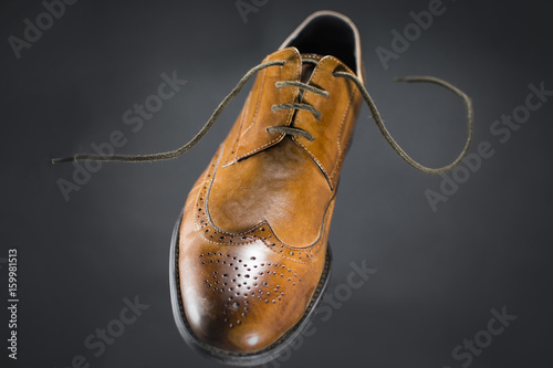 Beautiful brown leather men's shoes. Fashionable shoes isolated on black background.
