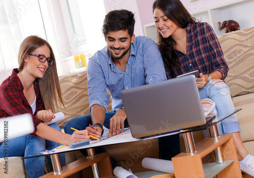 Three young students working together on a new project.