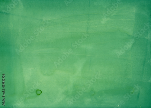 Organic green background with natural paper texture and spots for template of healthy food label, banner, print materials.
