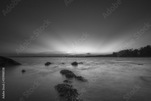 view of sunset at the beach in black and white mode