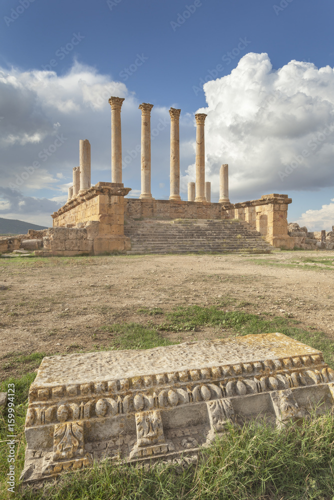Ruins of roman Capitolium in Thuburbo Majus with architrave in foreground, Tunisia