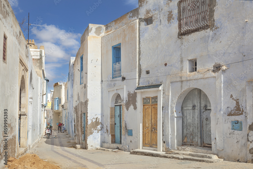 Street scene in the medina of Kairouan with white houses, Tunisia
