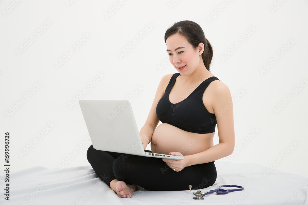 Pregnant Woman find health information on her computer Pregnant Woman find health information on her computer
